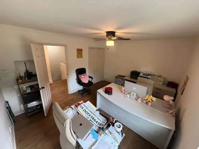 a bedroom with a bed closet and wooden floor