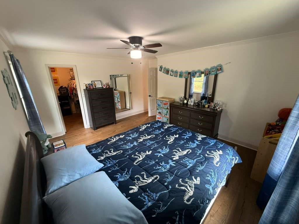 1463 Kellogg Creek Road Acworth, GA 30102 - Photo 49 of 55 a bedroom with a bed closet and wooden floor