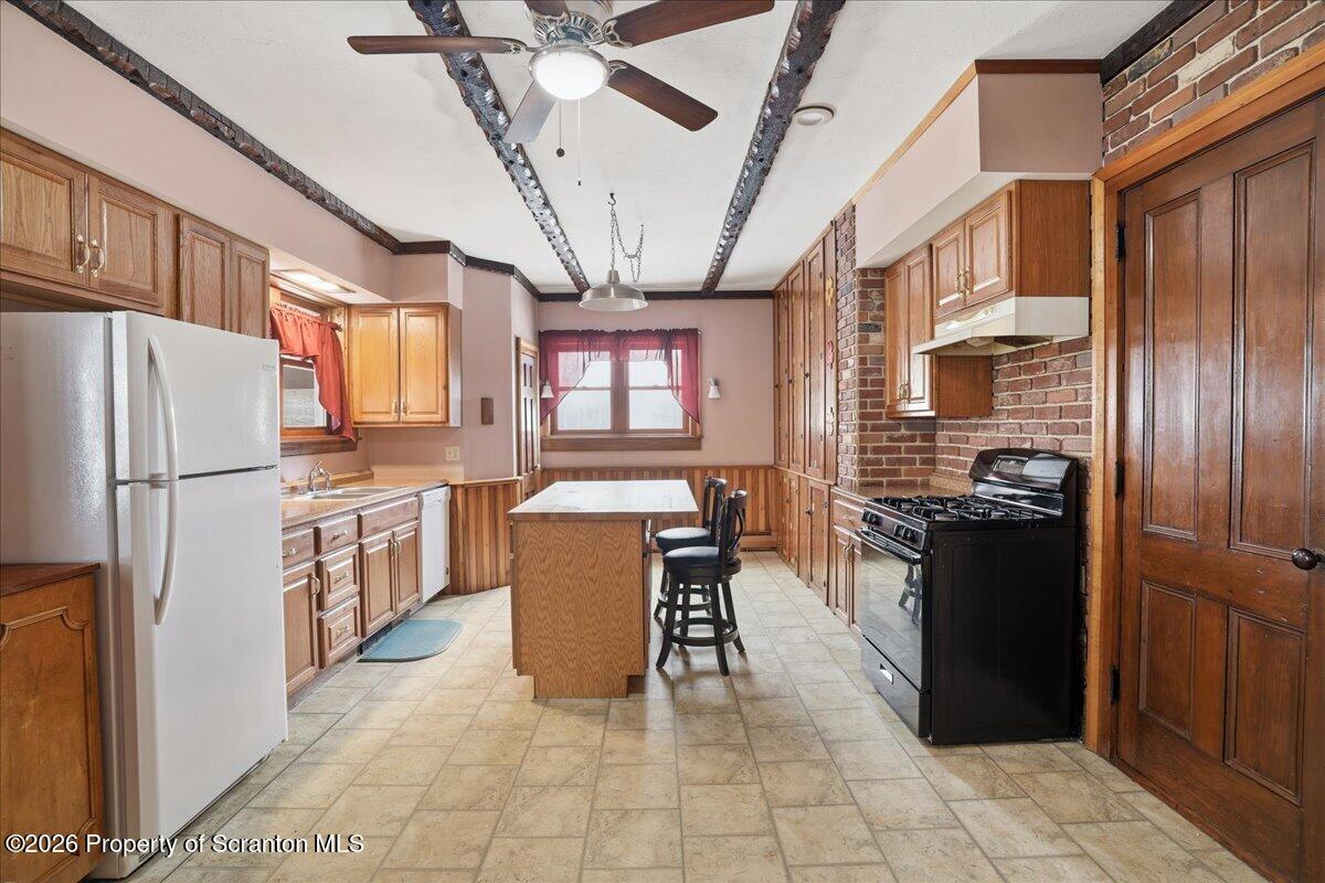 795 Wescott Road New Milford, PA 18834 - Photo 29 of 81 a kitchen with stainless steel appliances granite countertop a refrigerator a stove top oven a sink dishwasher and white cabinets