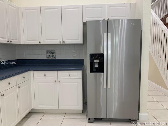 Silver Shores Miramar, FL 33027 - Photo 12 of 21 a kitchen with stainless steel appliances white cabinets and a refrigerator