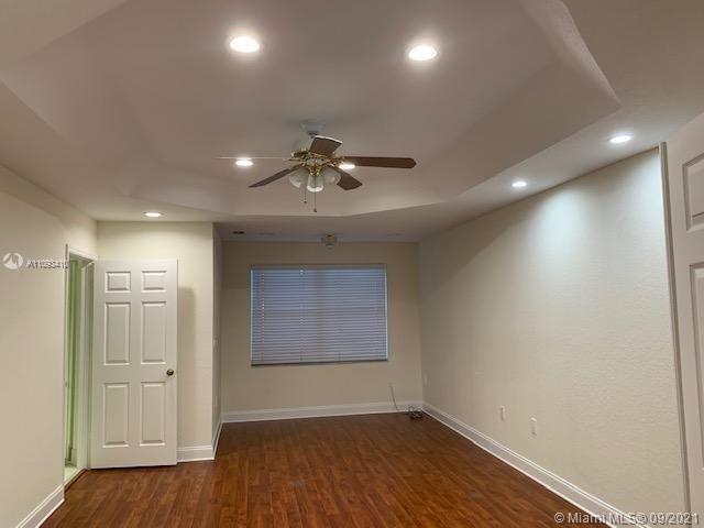 Silver Shores Miramar, FL 33027 - Photo 9 of 21 an empty room with wooden floor and windows