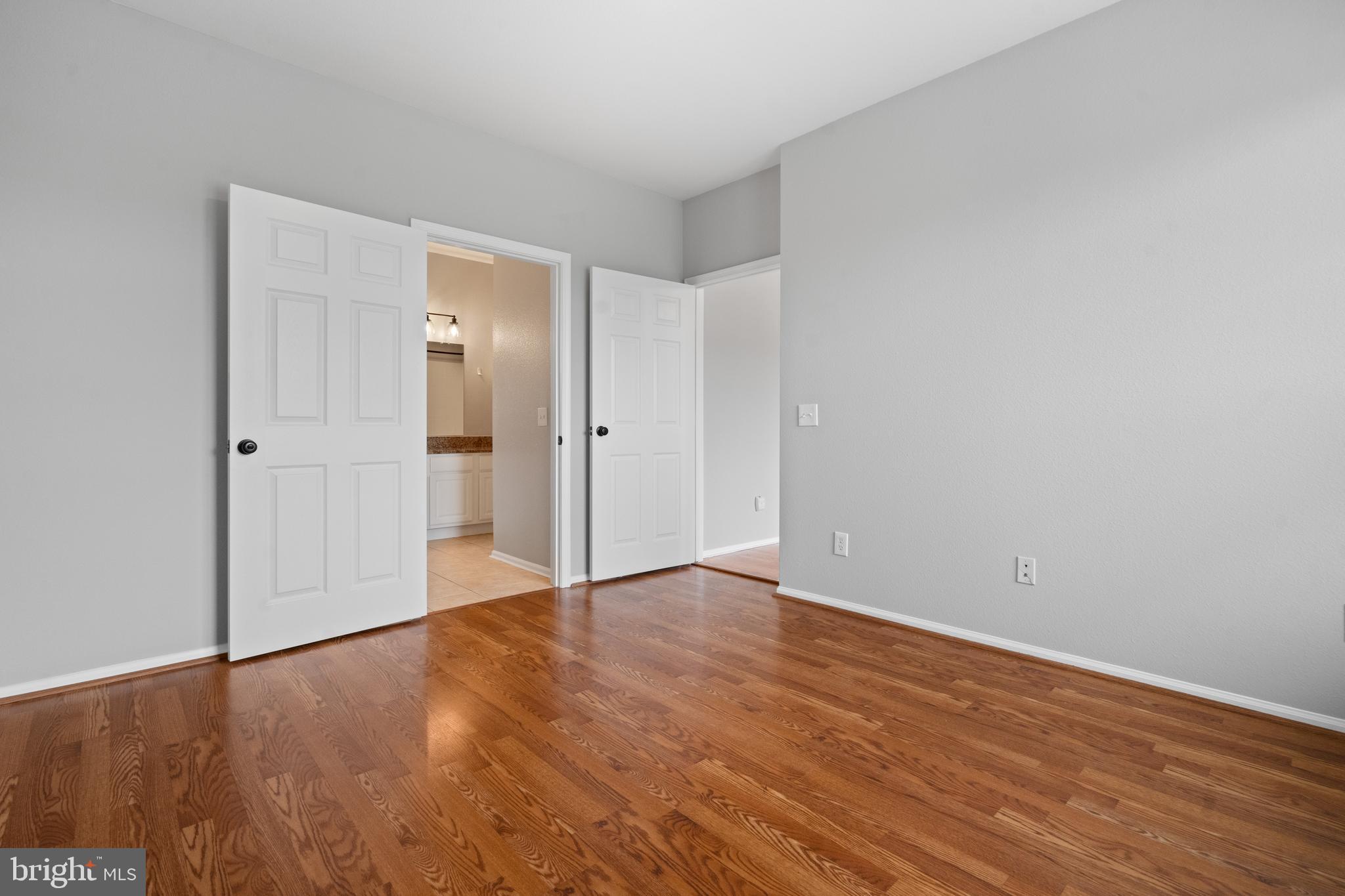 1550 Spring Gate Dr., Unit 8209 McLean, VA 22102 - Photo 14 of 40 a view of an empty room with wooden floor and closet area