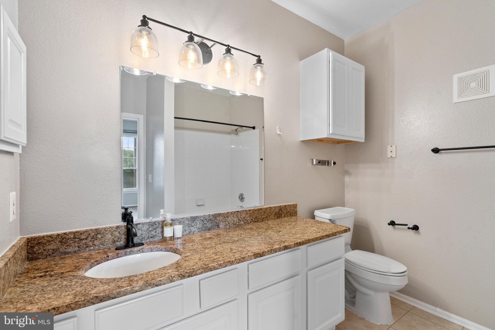1550 Spring Gate Dr., Unit 8209 McLean, VA 22102 - Photo 15 of 40 a bathroom with a granite countertop sink toilet and a mirror
