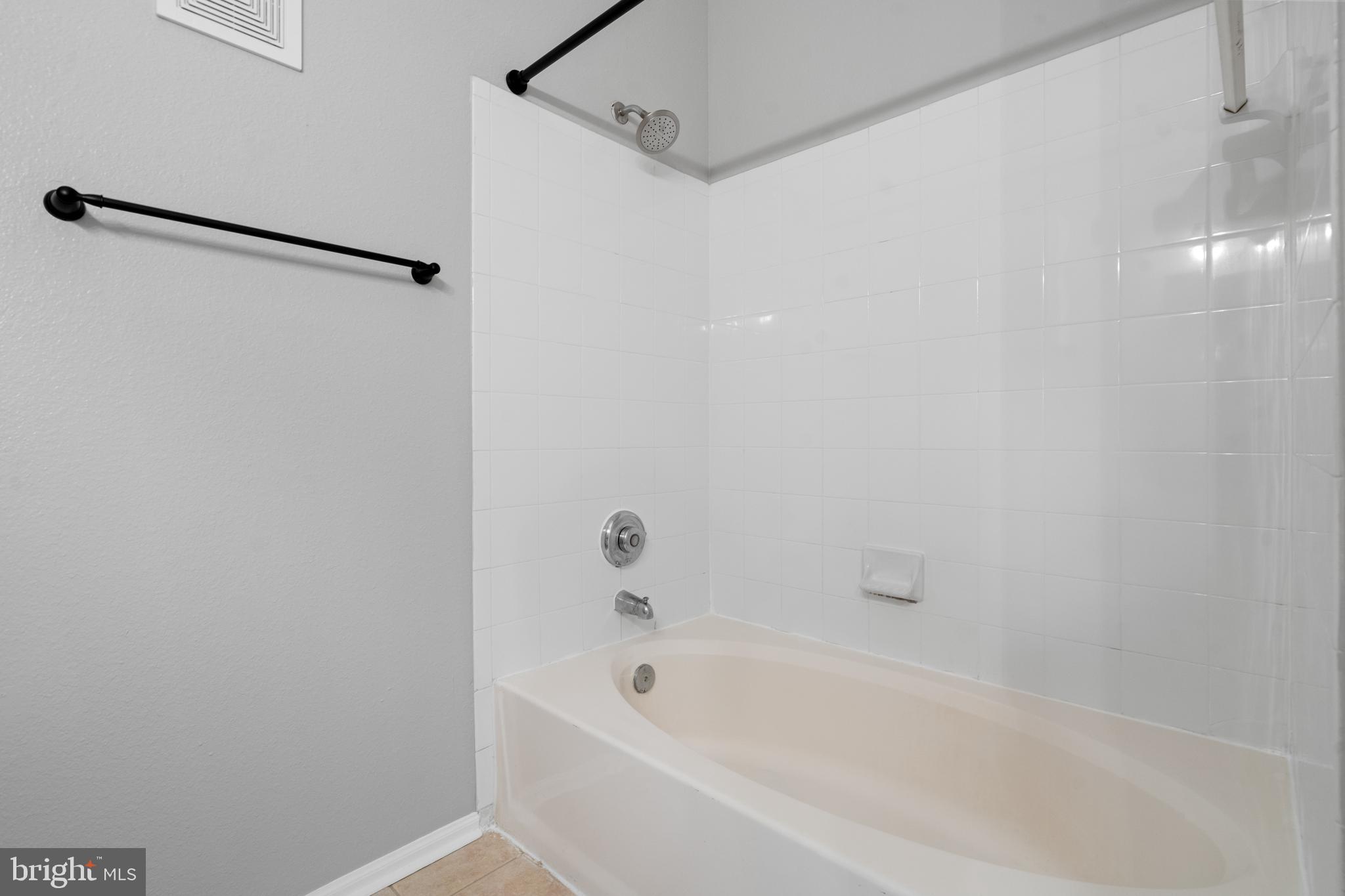 1550 Spring Gate Dr., Unit 8209 McLean, VA 22102 - Photo 16 of 40 a bathroom with a bathtub and a shower