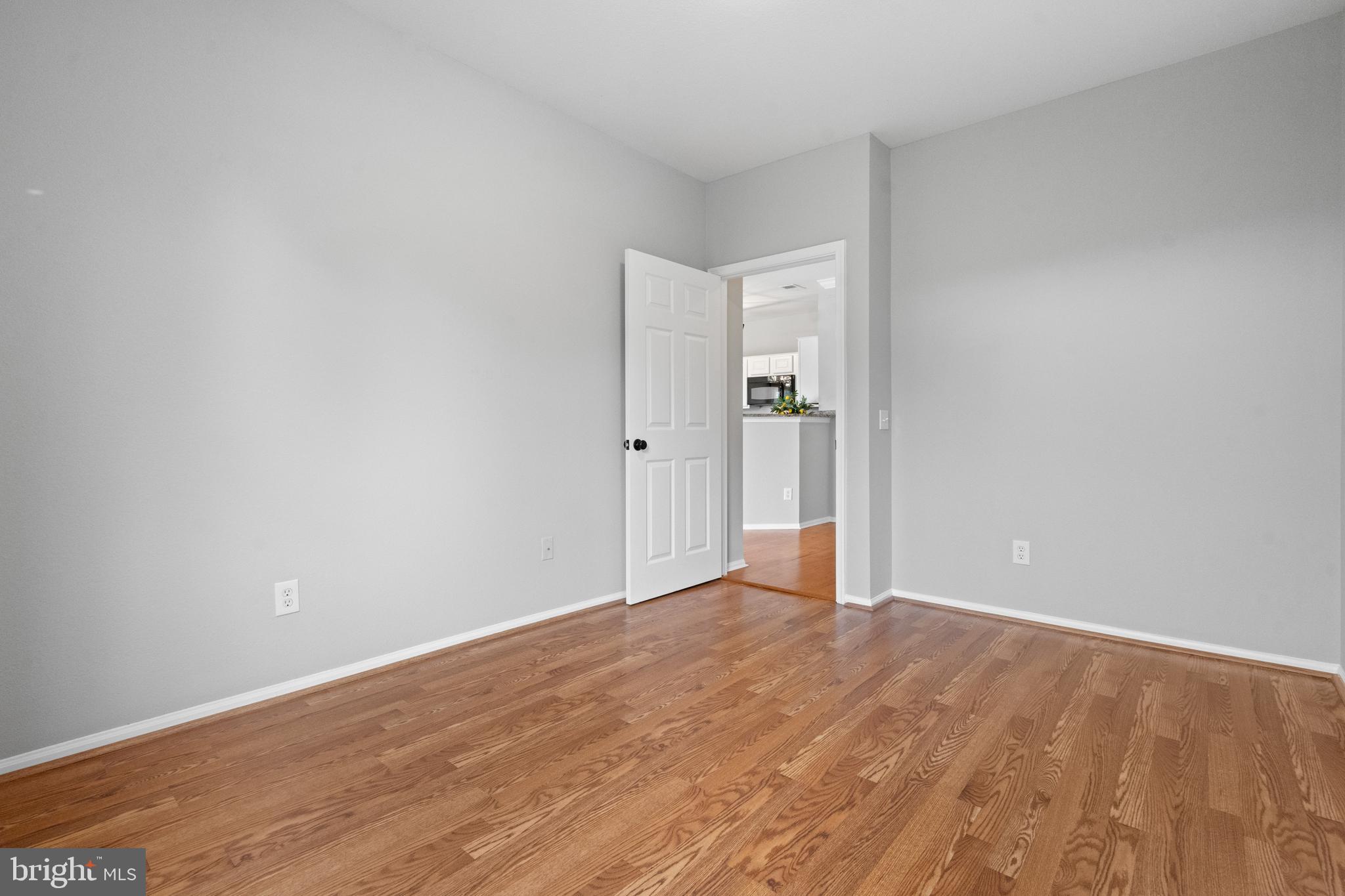 1550 Spring Gate Dr., Unit 8209 McLean, VA 22102 - Photo 19 of 40 a view of an empty room with wooden floor