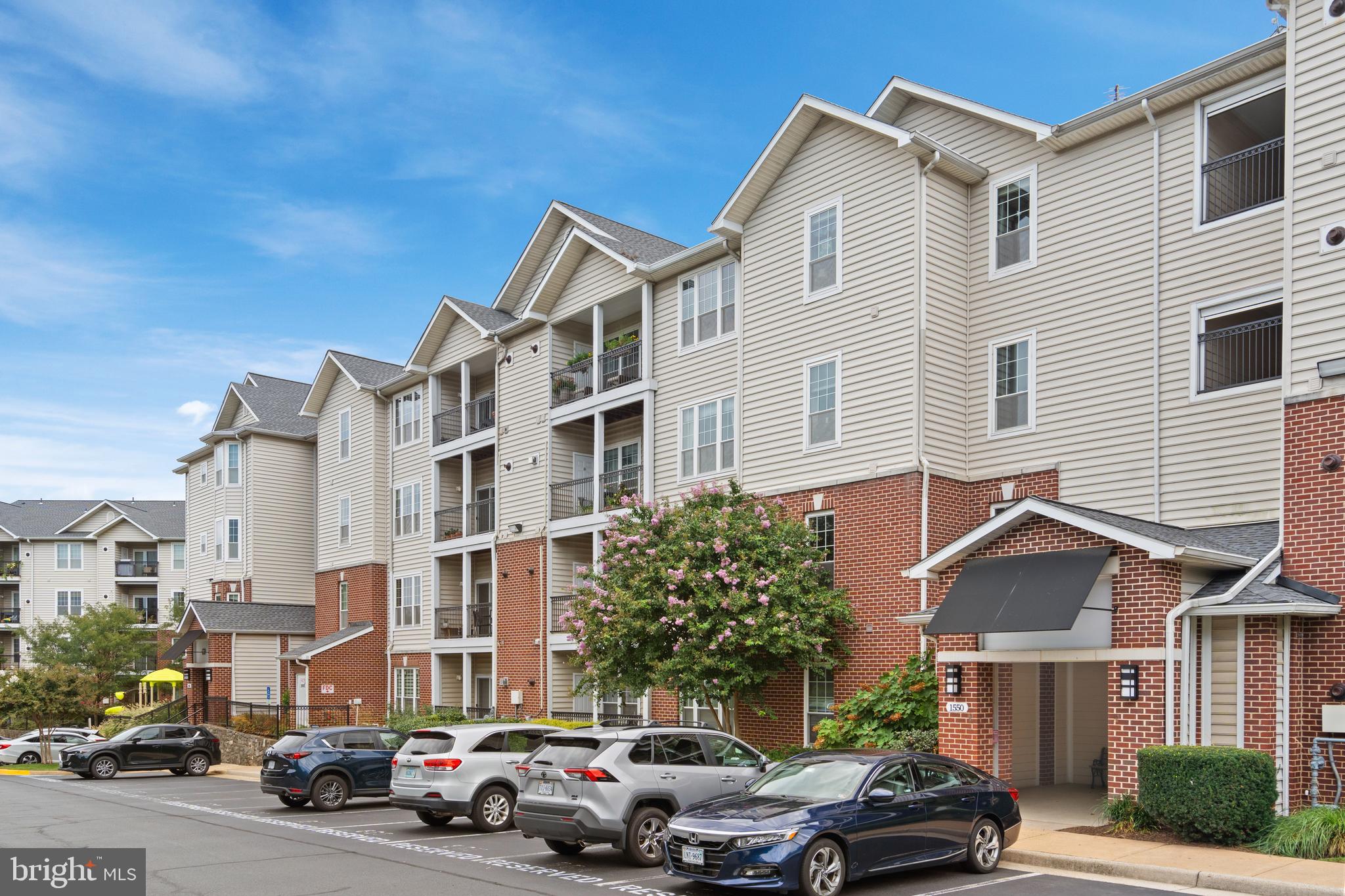 1550 Spring Gate Dr., Unit 8209 McLean, VA 22102 - Photo 2 of 40 a couple of cars parked in front of a white house