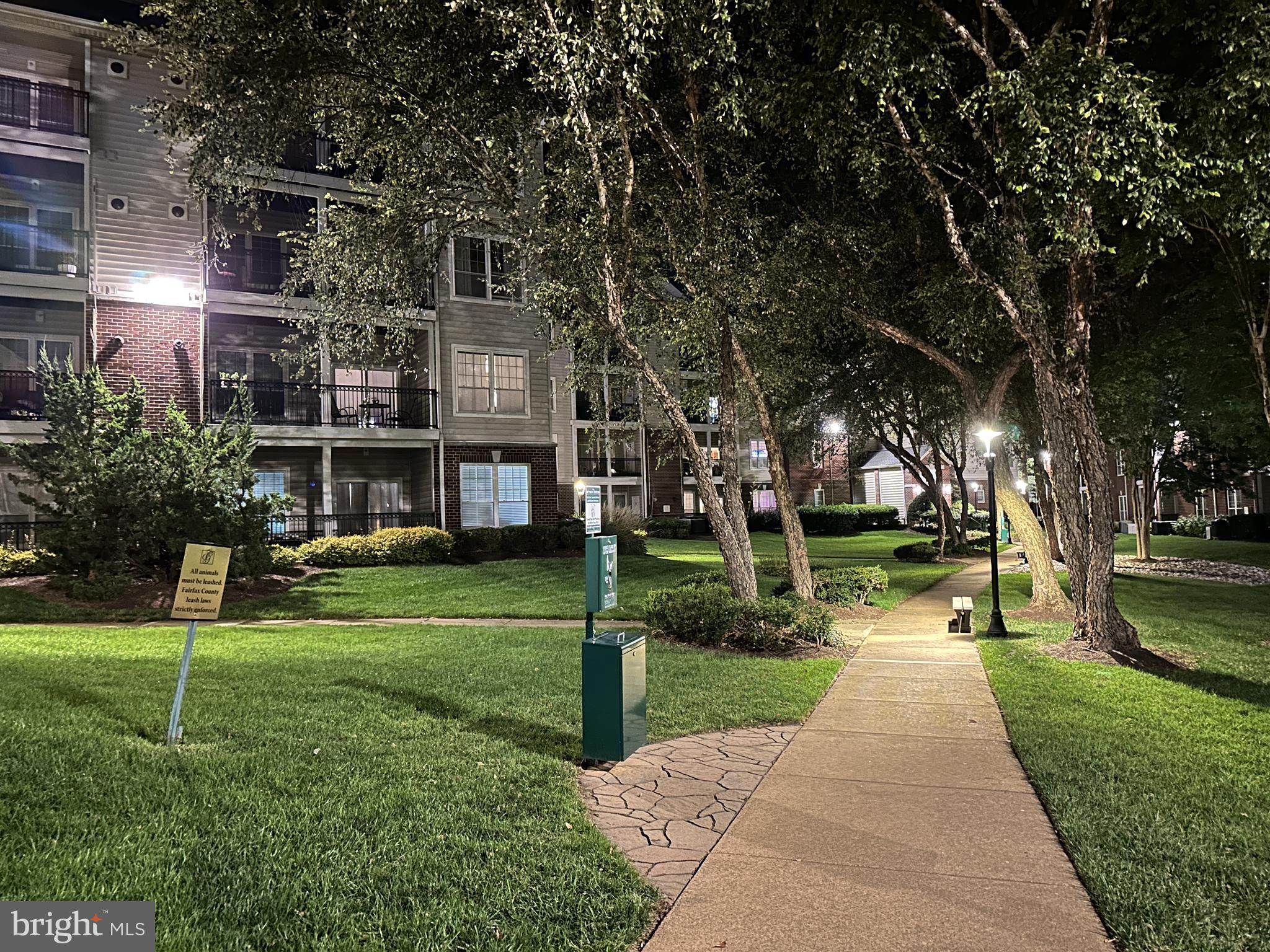 1550 Spring Gate Dr., Unit 8209 McLean, VA 22102 - Photo 34 of 40 a front view of a house with a yard