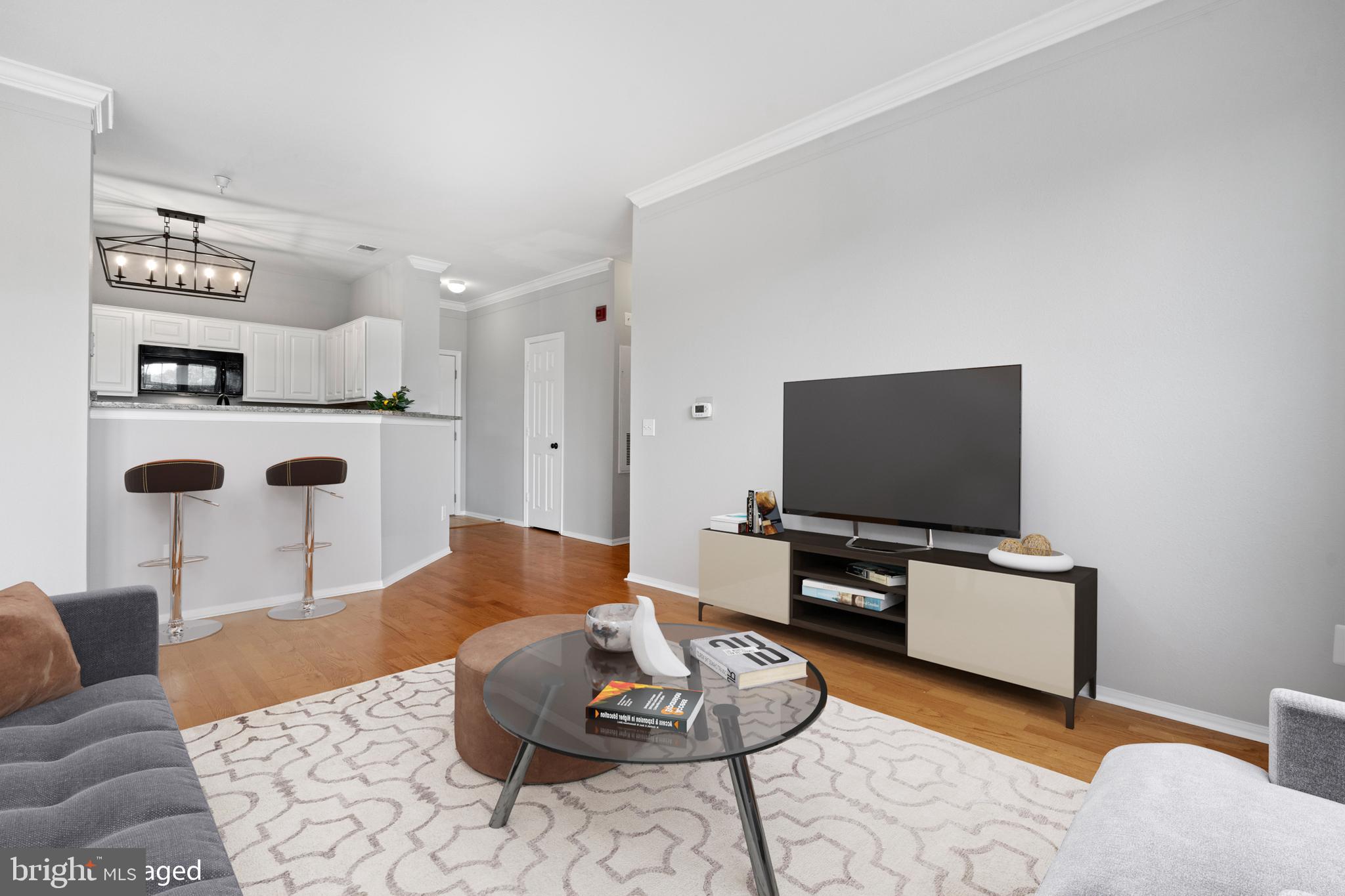 1550 Spring Gate Dr., Unit 8209 McLean, VA 22102 - Photo 5 of 40 a living room with furniture and a flat screen tv