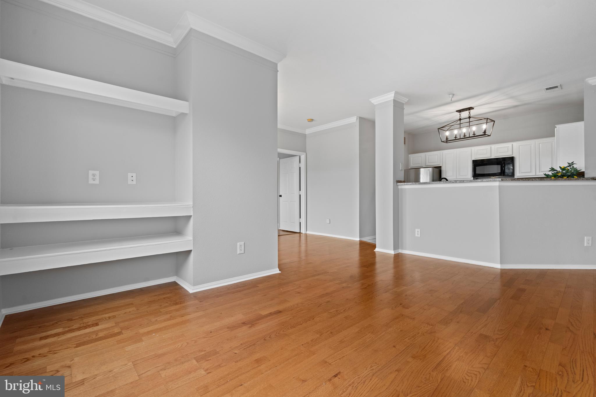 1550 Spring Gate Dr., Unit 8209 McLean, VA 22102 - Photo 7 of 40 a view of a kitchen with wooden floor and electronic appliances