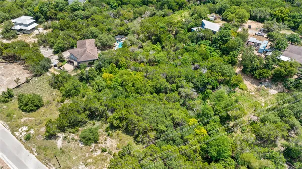an aerial view of a house with swimming pool and outdoor seating