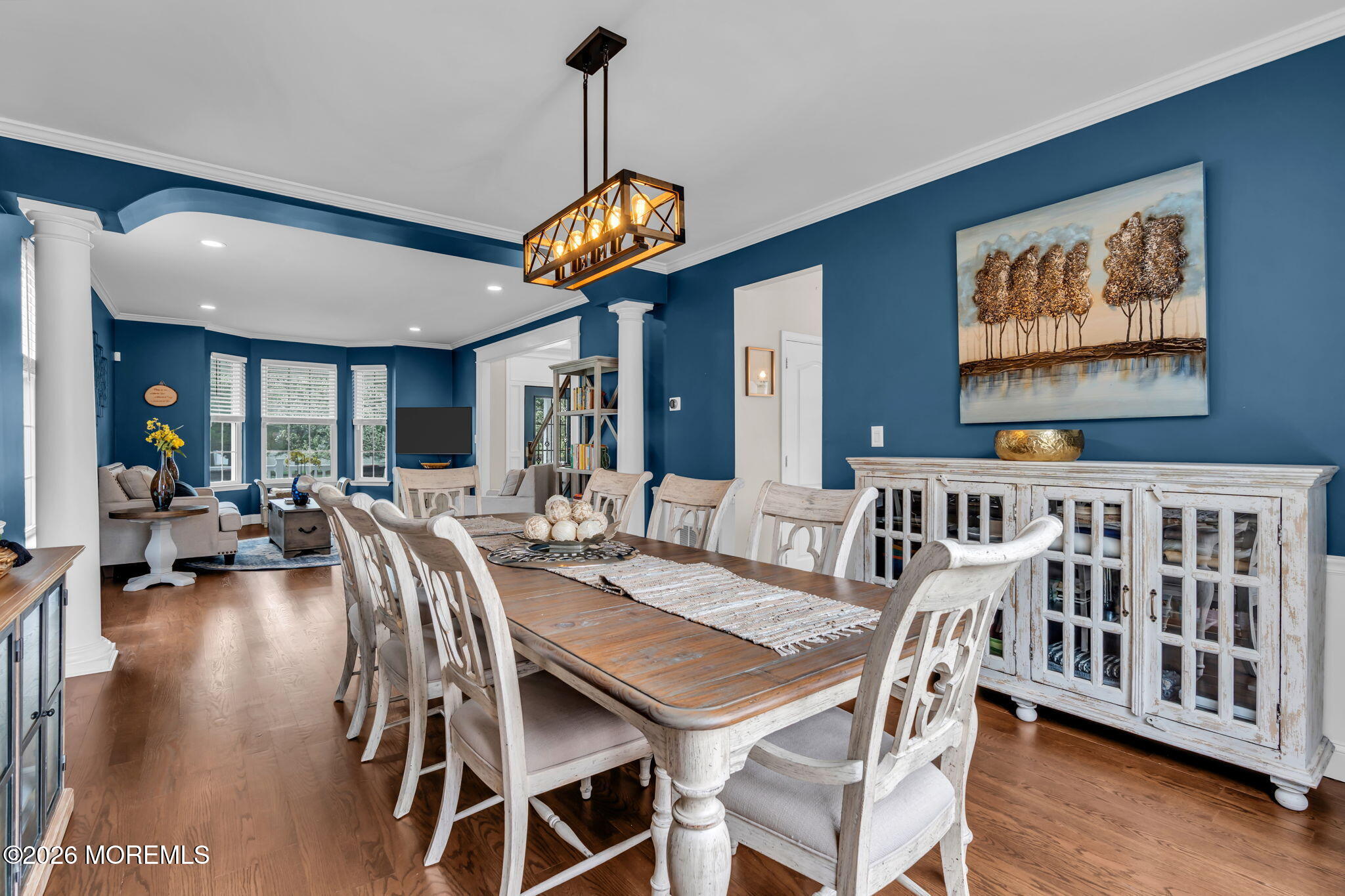 41 Lafayette Mills Road Manalapan, NJ 07726 - Photo 12 of 75 a view of a dining room and livingroom with furniture wooden floor a chandelier