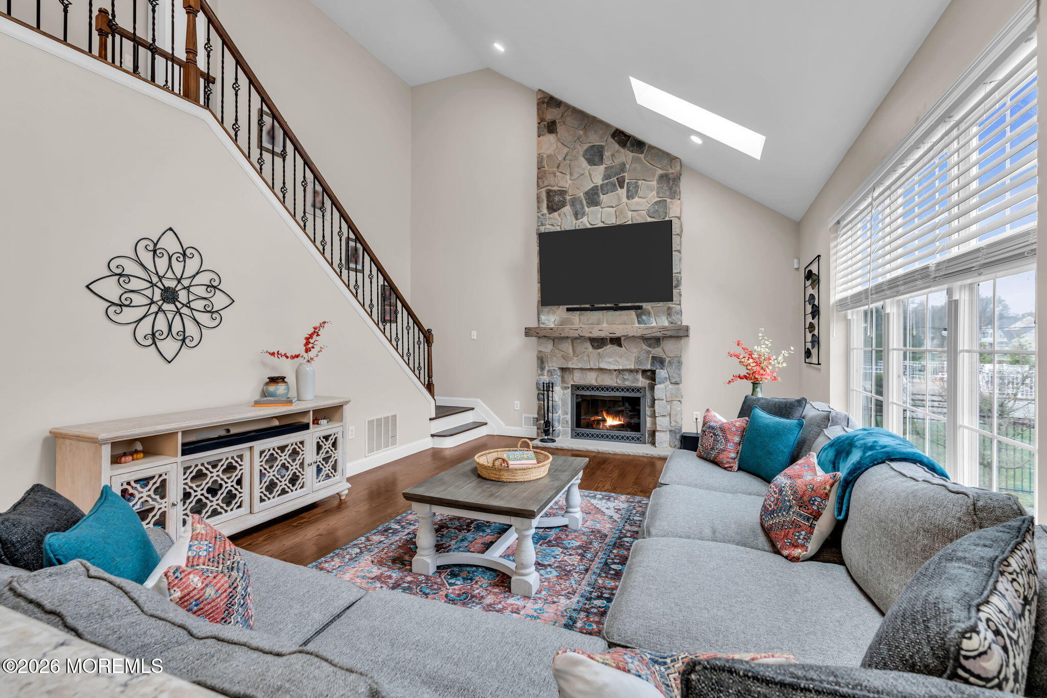 41 Lafayette Mills Road Manalapan, NJ 07726 - Photo 22 of 75 a living room with furniture a flat screen tv and a fireplace