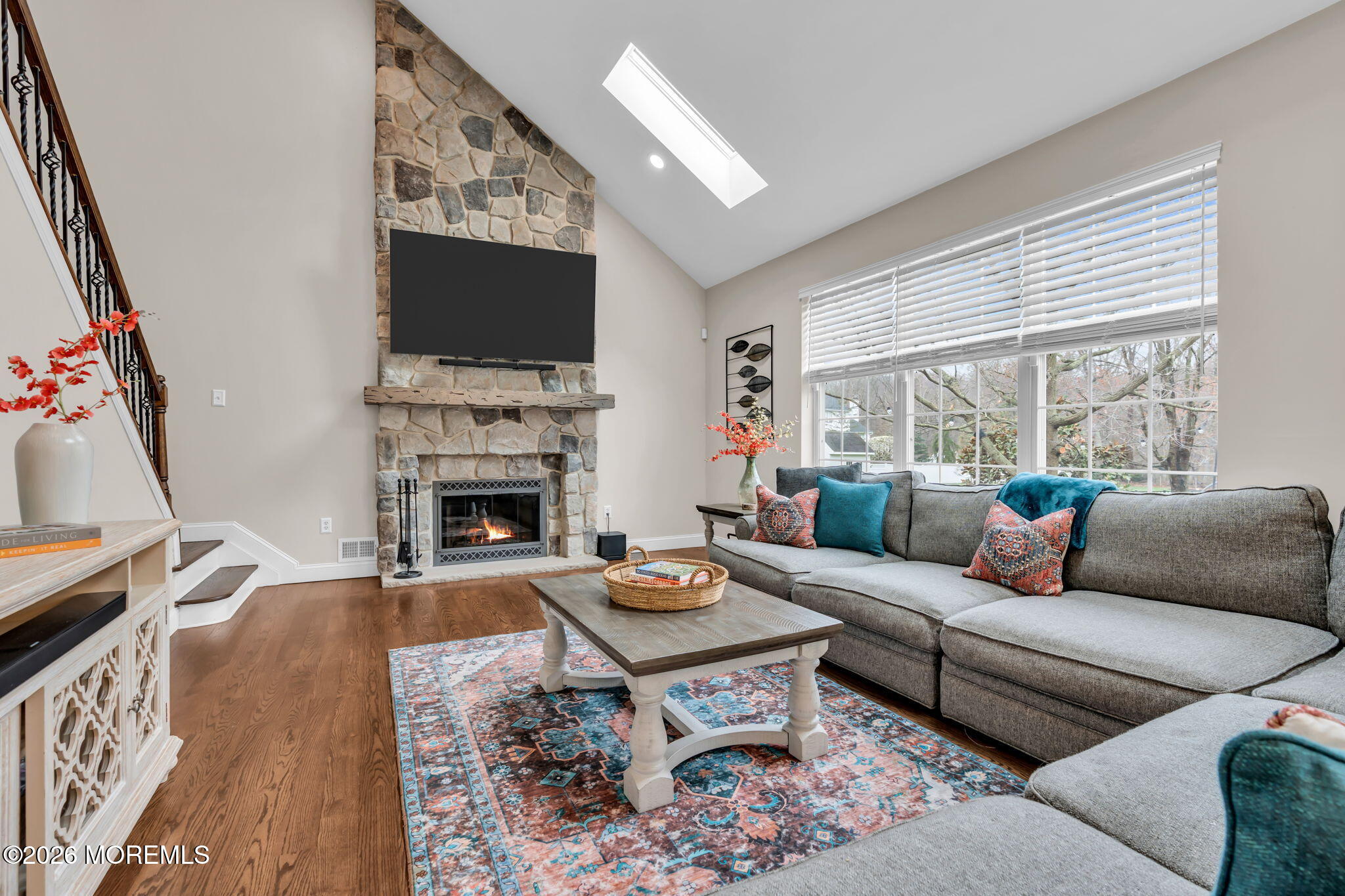 41 Lafayette Mills Road Manalapan, NJ 07726 - Photo 23 of 75 a living room with furniture a flat screen tv and a fireplace
