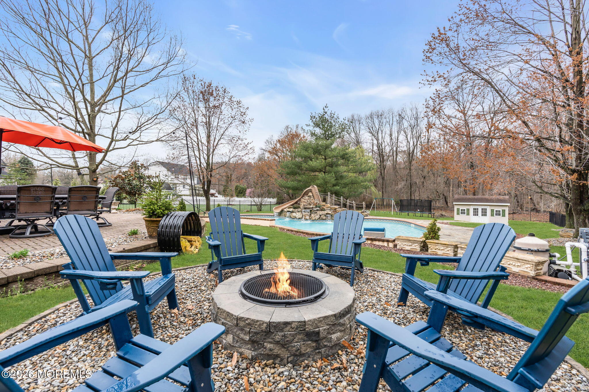 41 Lafayette Mills Road Manalapan, NJ 07726 - Photo 67 of 75 a backyard of a house with fire pit and outdoor seating