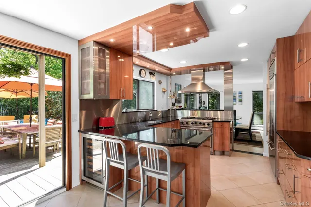 a dining room with furniture a large window and a chandelier