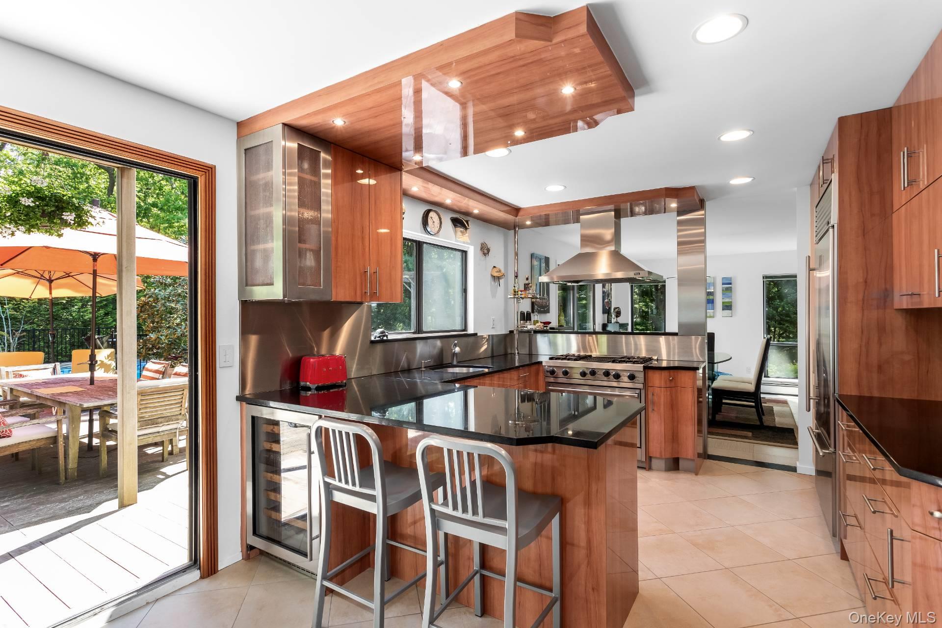 a dining room with furniture a large window and a chandelier