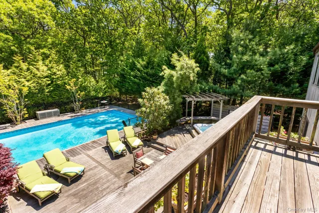 a view of deck with furniture and trees
