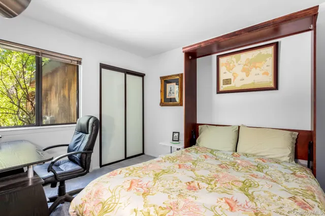 a bedroom with a bed and chair