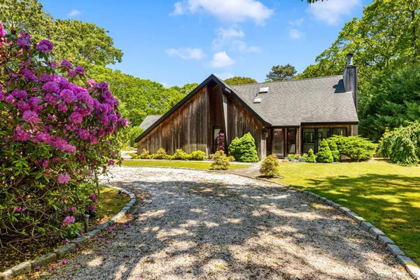 a view of a house with a yard and garden