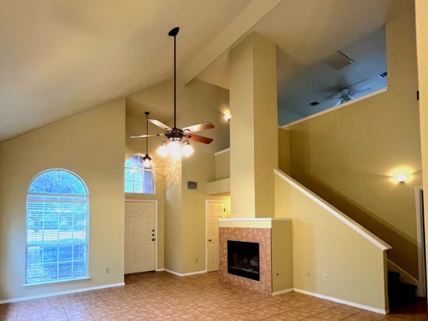 132 Stephen Lane Georgetown, TX 78626 - Photo 2 of 13 Vaulted ceiling living room with ceiling fan and a tile fireplace