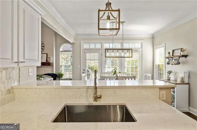 a kitchen with stainless steel appliances a refrigerator sink and microwave