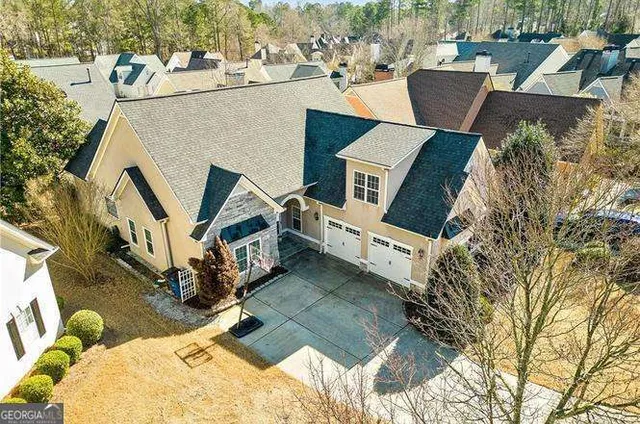an aerial view of a house with table and chairs