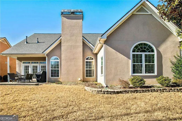 a patio with yard glass top table and chairs