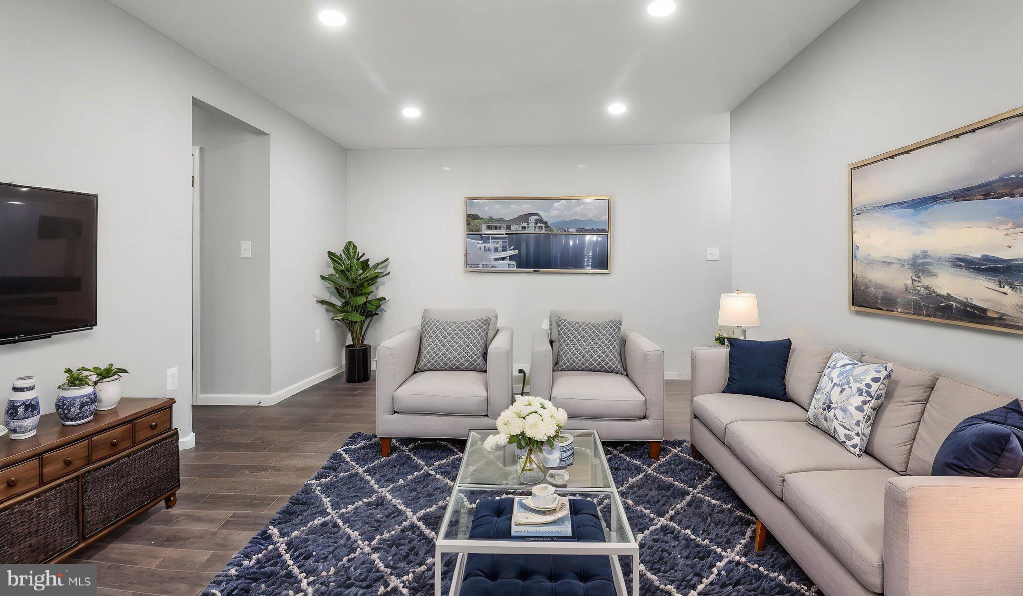 a living room with furniture and a flat screen tv