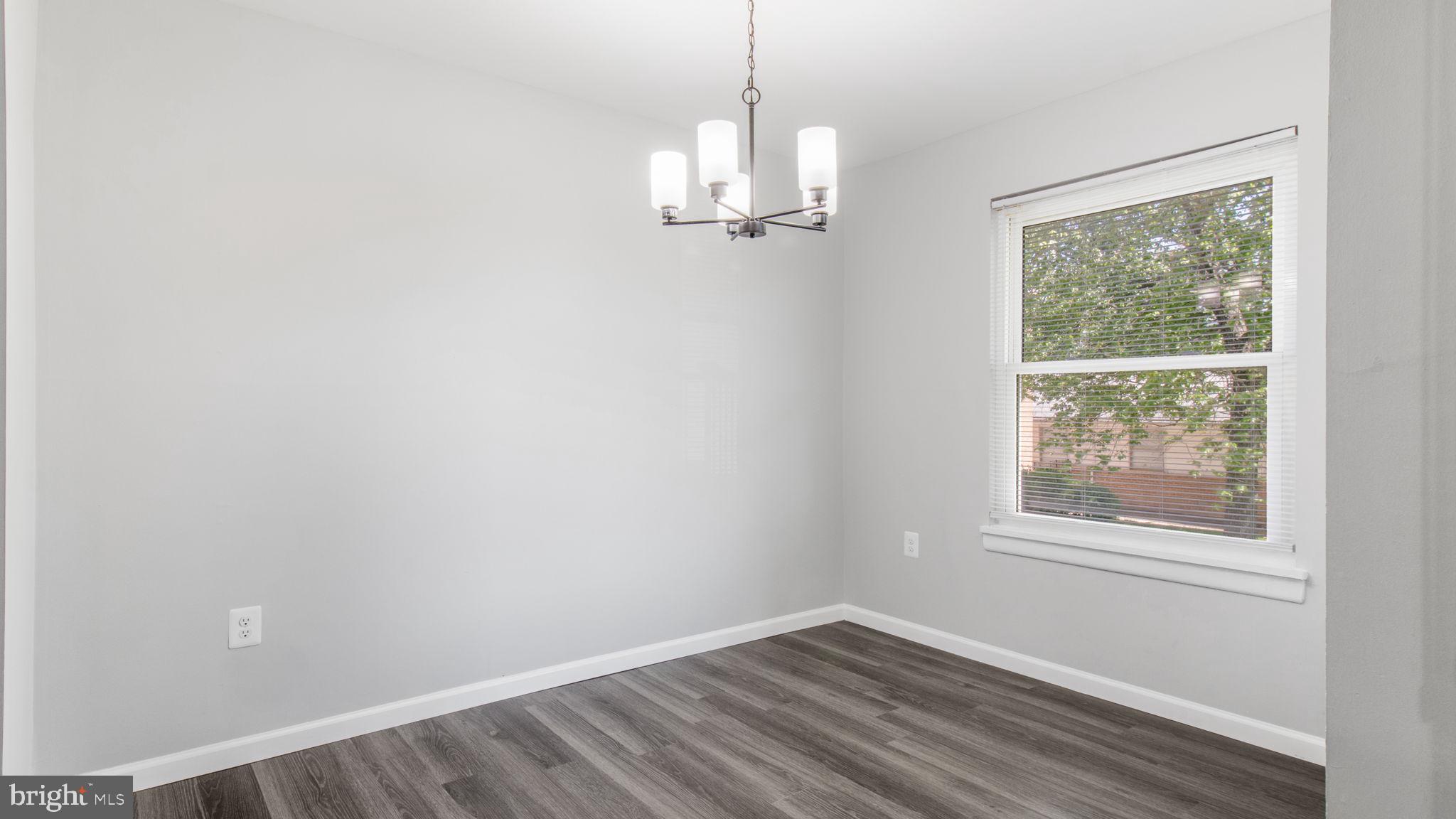3851 St Barnabas Road, Unit 103 Suitland, MD 20746 - Photo 11 of 43 an empty room with wooden floor and windows