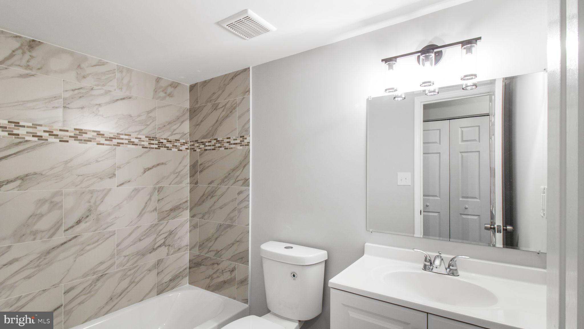 3851 St Barnabas Road, Unit 103 Suitland, MD 20746 - Photo 13 of 43 a bathroom with a sink a toilet and shower