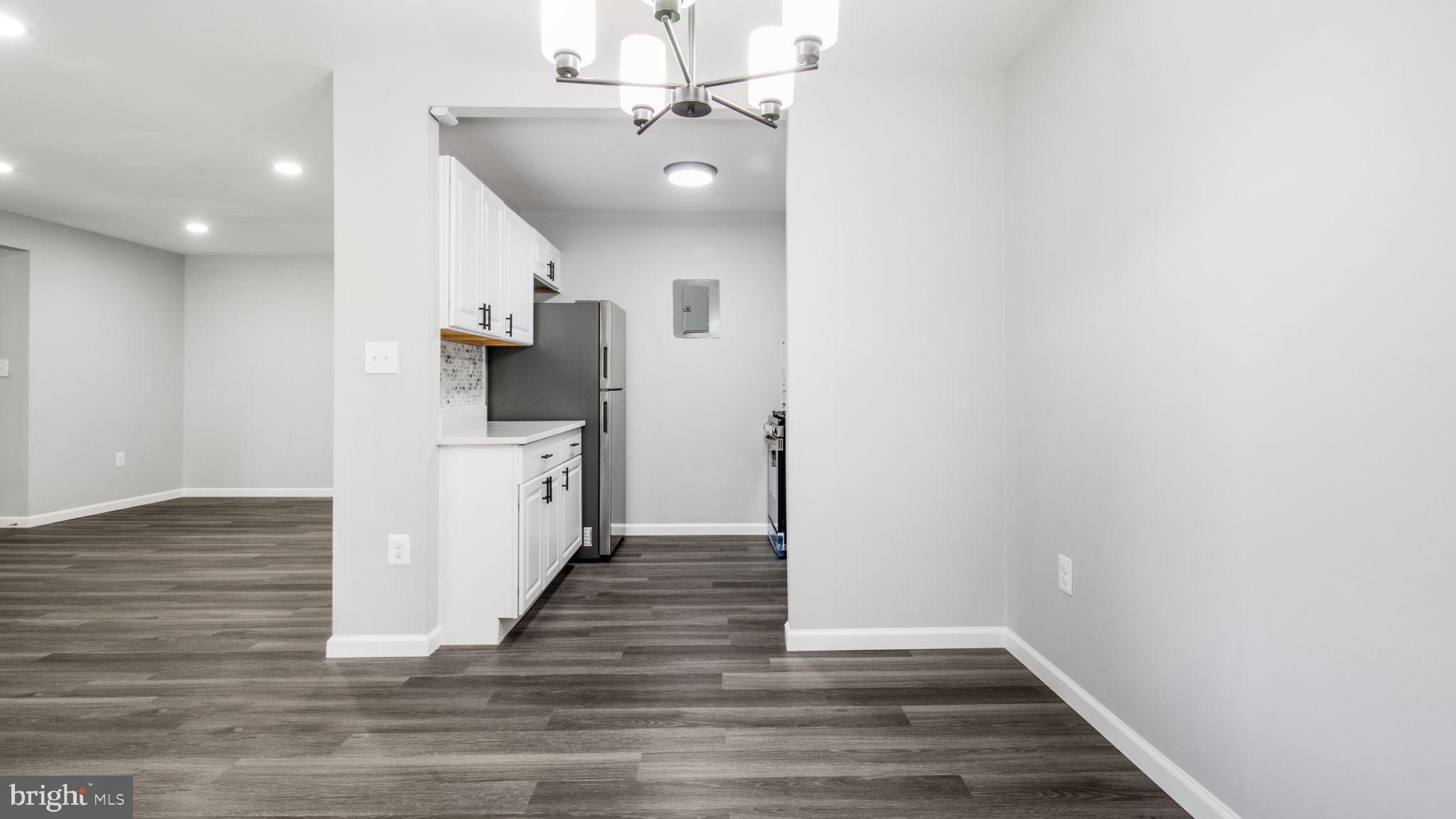 3851 St Barnabas Road, Unit 103 Suitland, MD 20746 - Photo 27 of 43 a view of a hallway with wooden floor