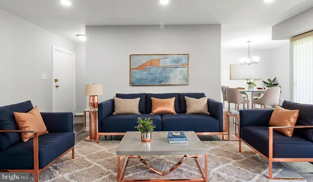 a living room with furniture and a painting