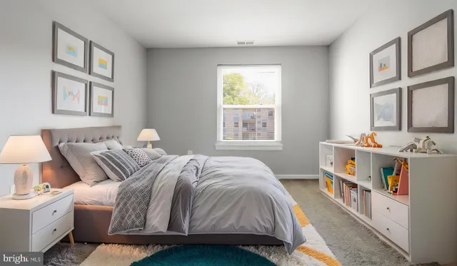 a bedroom with a bed and a window