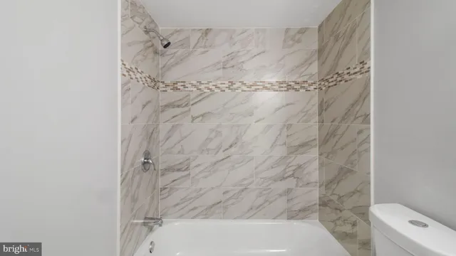 a bathroom with a bathtub and shower