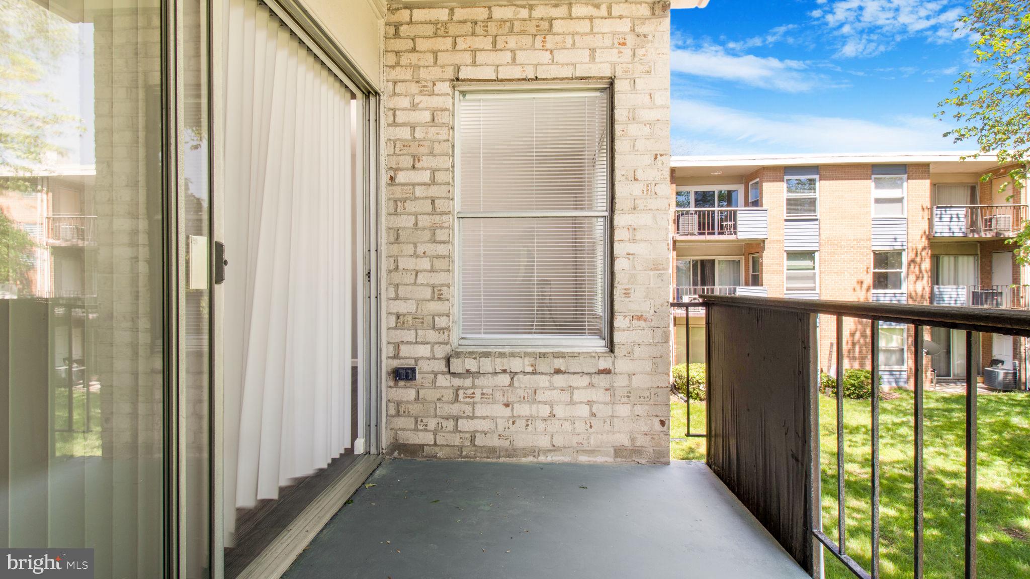 3851 St Barnabas Road, Unit 103 Suitland, MD 20746 - Photo 7 of 43 a view of a balcony with a door and wooden floor