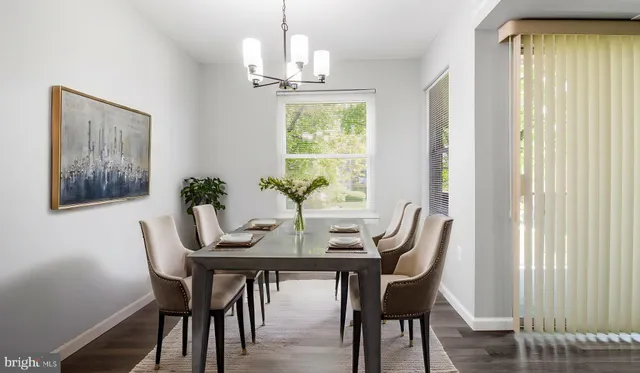 a view of a dining room with furniture window and wooden floor