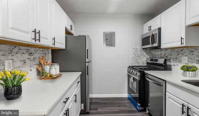 a kitchen with stainless steel appliances a sink a stove and a refrigerator