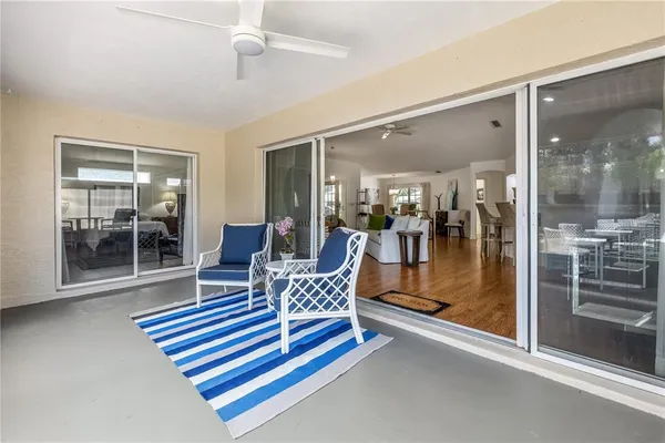 a living room with furniture and a glass door