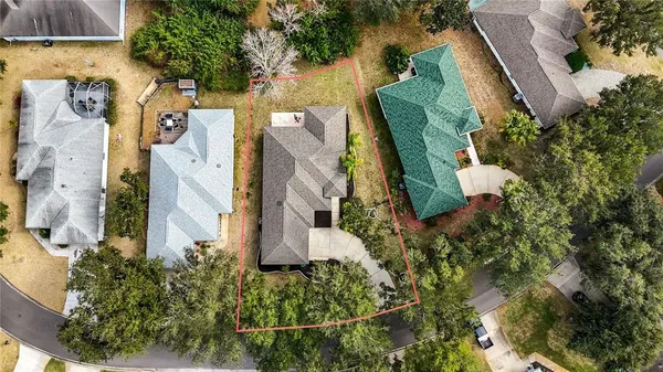 an aerial view of a house with garden space and street view