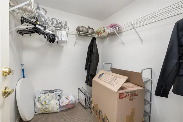a view of storage and utility room with two washing machine