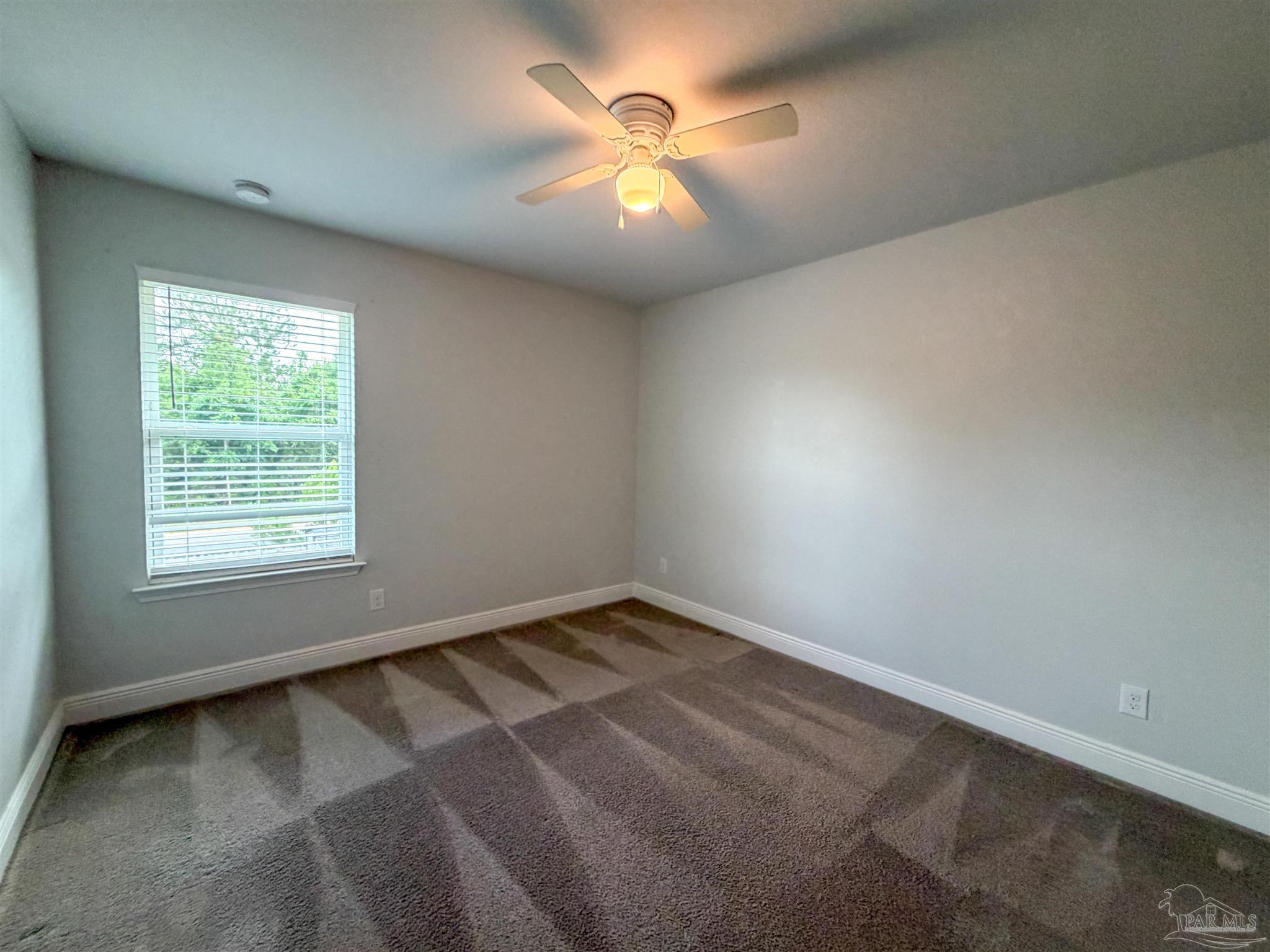 3613 Conley Drive Cantonment, FL 32533 - Photo 23 of 32 an empty room with a window and a fan