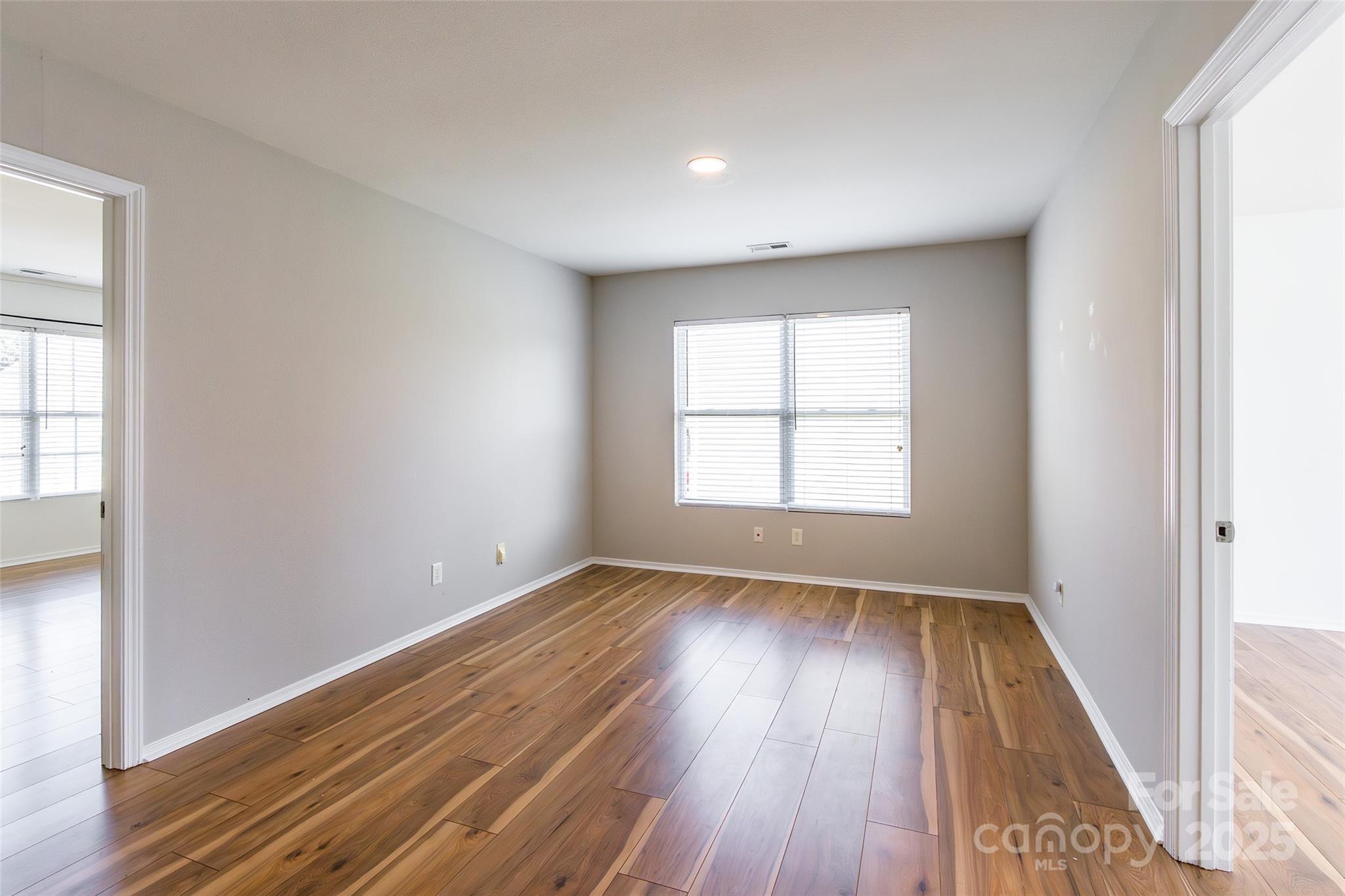2357 Riding Trail Road Gastonia, NC 28054 - Photo 14 of 32 an empty room with wooden floor and windows