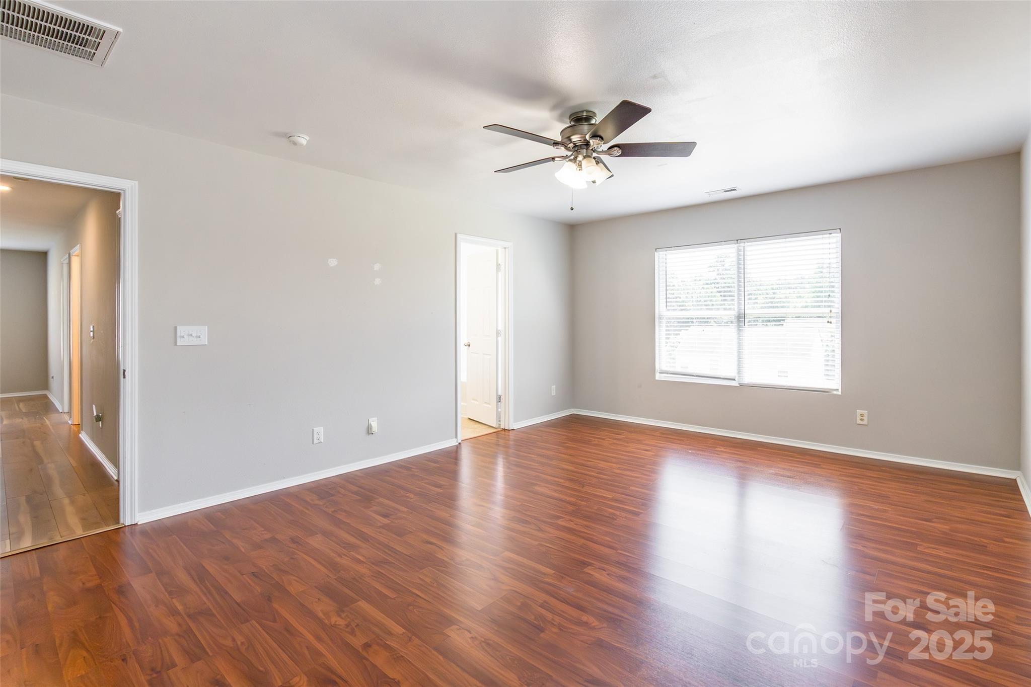 2357 Riding Trail Road Gastonia, NC 28054 - Photo 17 of 32 a view of an empty room with wooden floor and a window