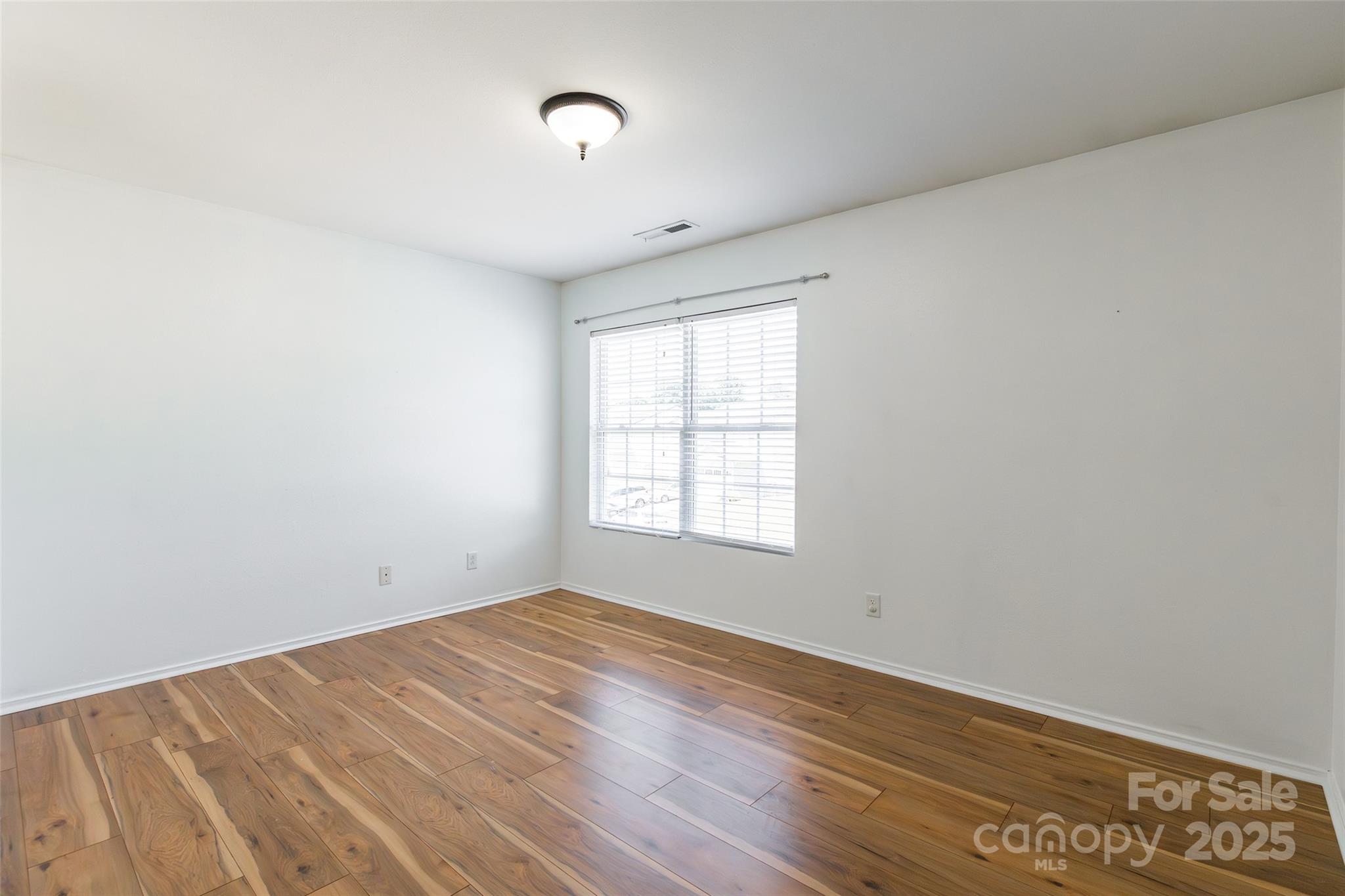 2357 Riding Trail Road Gastonia, NC 28054 - Photo 20 of 32 an empty room with wooden floor and windows