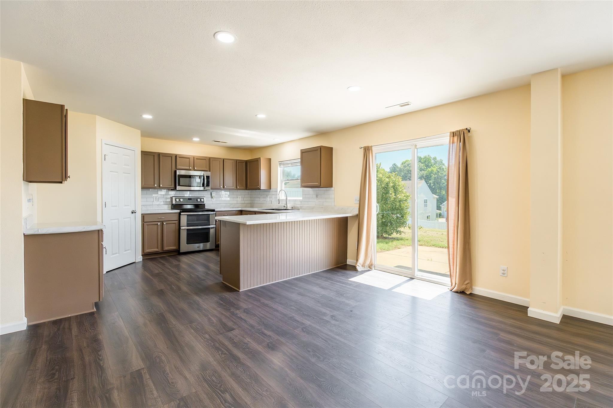 2357 Riding Trail Road Gastonia, NC 28054 - Photo 2 of 32 a view of kitchen with granite countertop stainless steel appliances cabinets and wooden floor