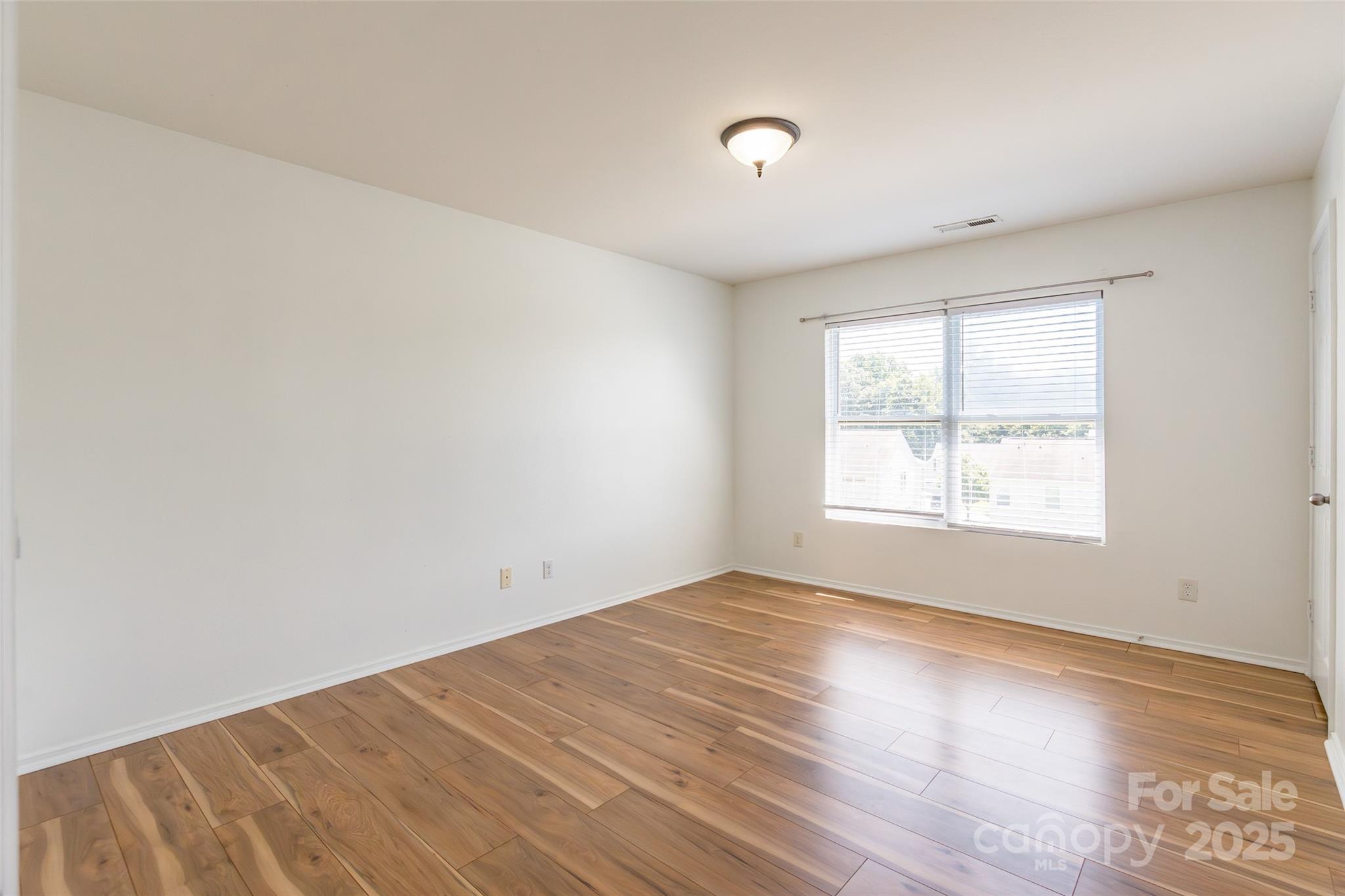2357 Riding Trail Road Gastonia, NC 28054 - Photo 22 of 32 an empty room with wooden floor and windows