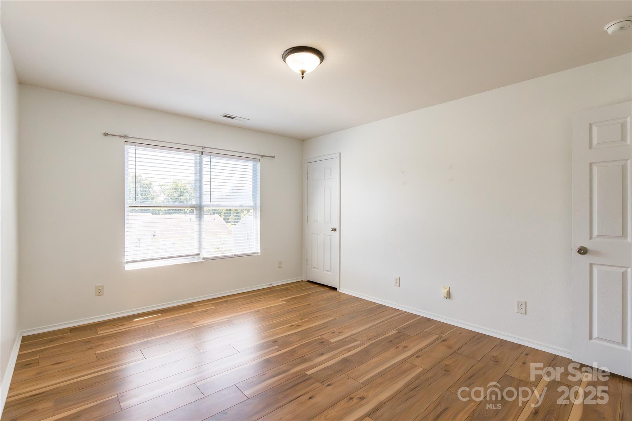 2357 Riding Trail Road Gastonia, NC 28054 - Photo 23 of 32 a view of an empty room with wooden floor and a window