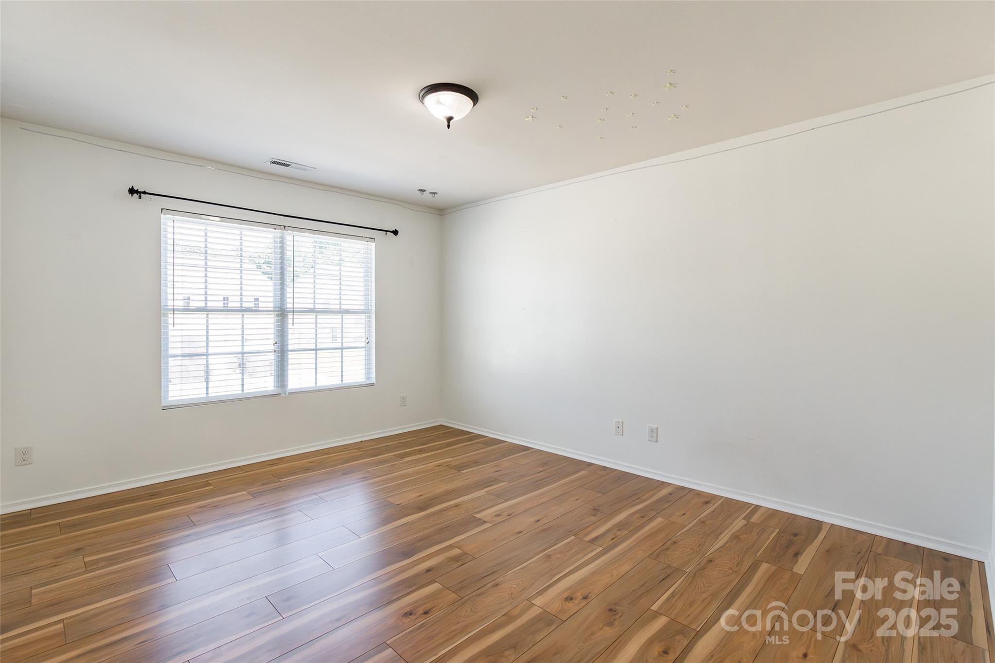 2357 Riding Trail Road Gastonia, NC 28054 - Photo 24 of 32 an empty room with wooden floor and windows
