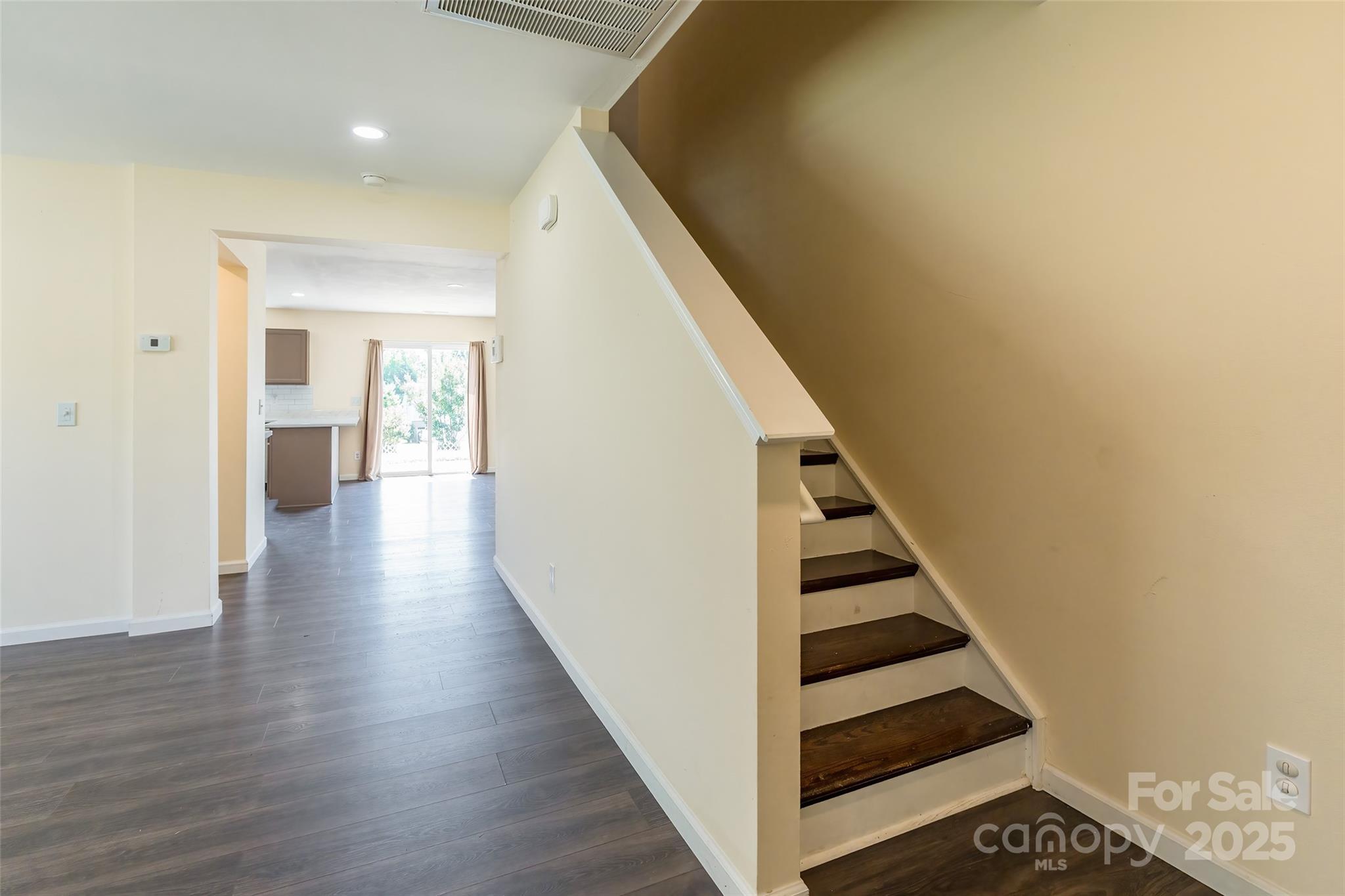 2357 Riding Trail Road Gastonia, NC 28054 - Photo 3 of 32 a view of a hallway with stairs and wooden floor