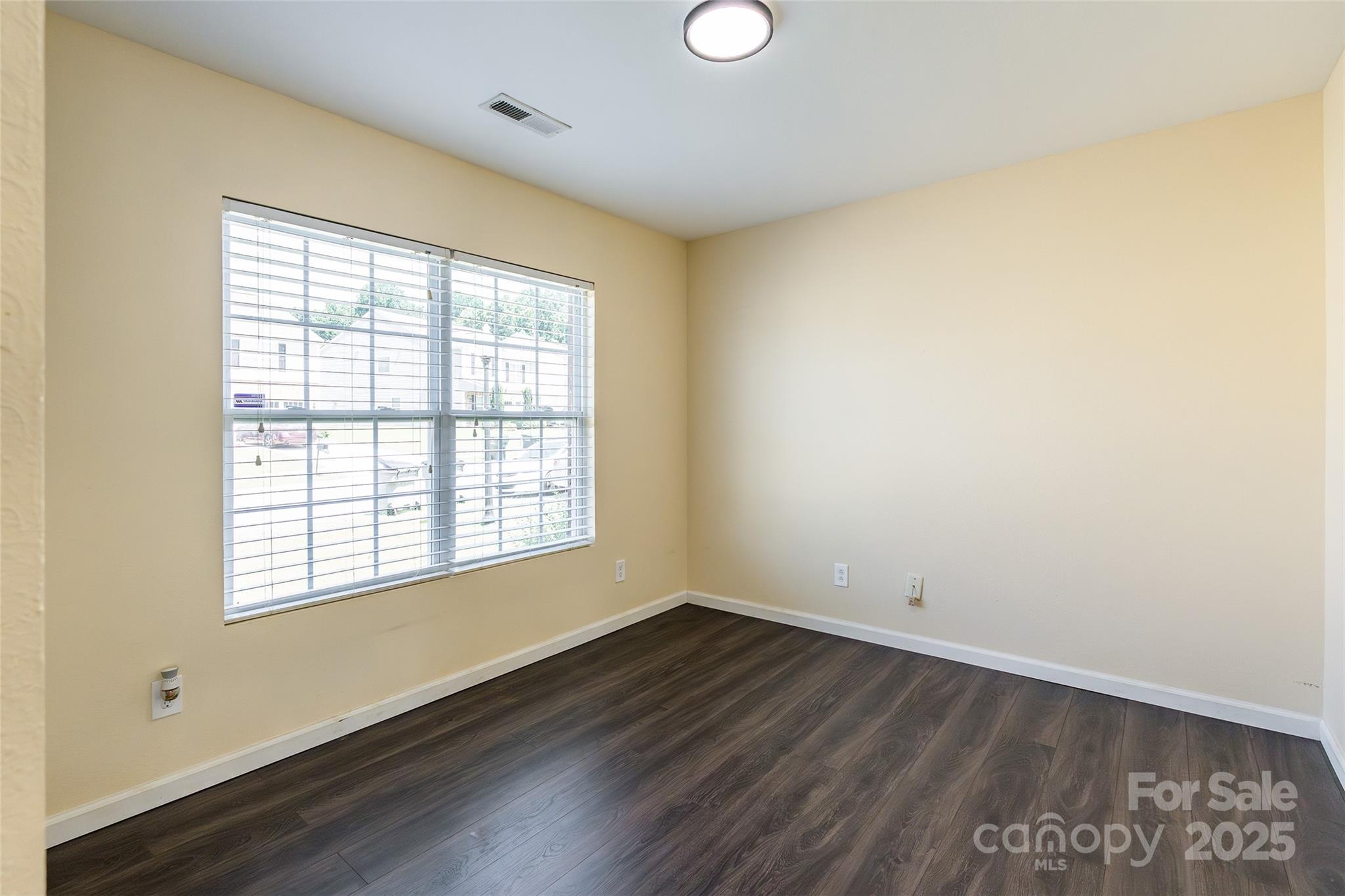 2357 Riding Trail Road Gastonia, NC 28054 - Photo 4 of 32 an empty room with wooden floor and windows